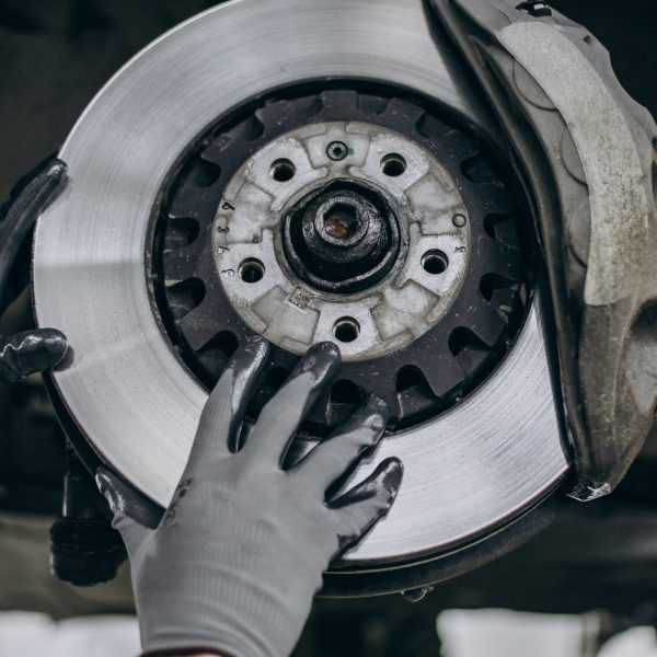 Mechanic changing brake discs in car service